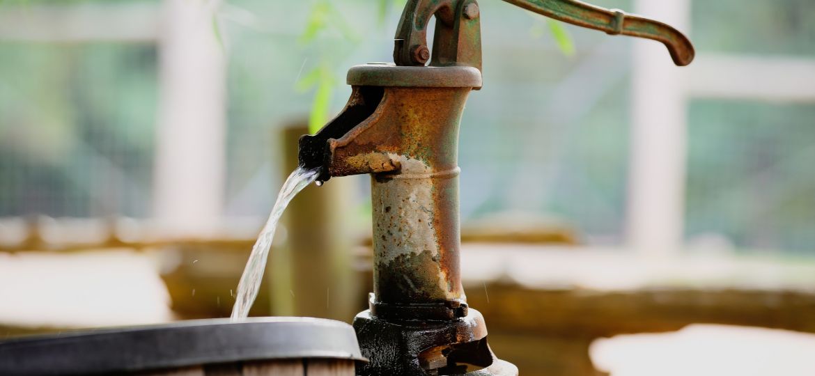 outdoor well tap pouring water