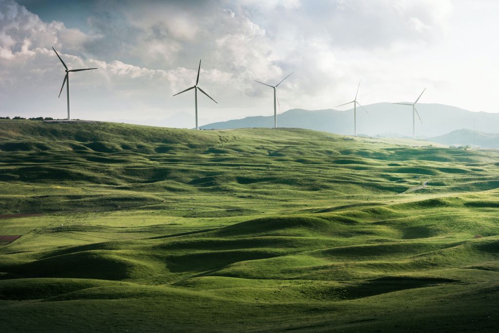 Wind mills on a green hill 