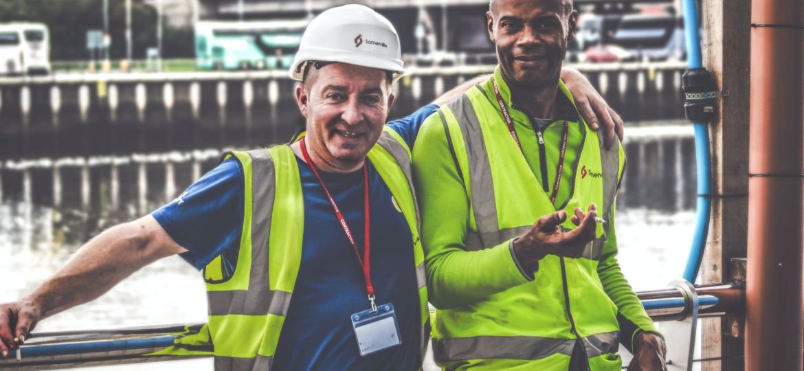Two workers smiling