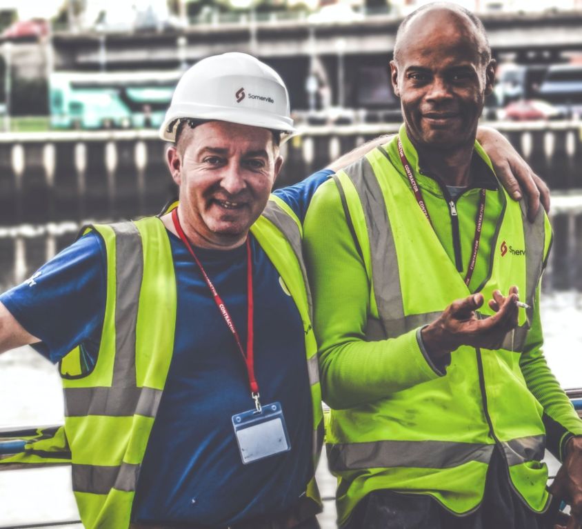 Two workers smiling